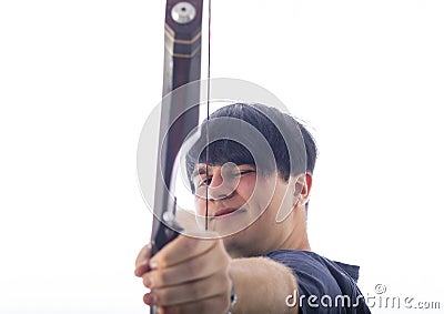 Portrait of a European young man, 21 years old, against a white background, spans a takedown recurved bow and aims Stock Photo