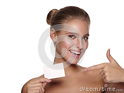 Portrait of an european young smiling girl with healthy perfect smooth skin, who is holding a business visiting card Stock Photo
