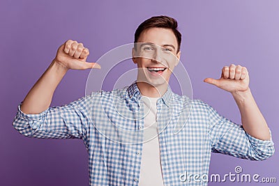 Portrait of excited boasting guy open mouth indicate thumb himself on purple background Stock Photo