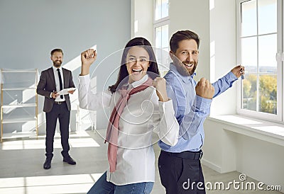 Portrait of excited family who are joyfully clenching their fists while buying their own home. Stock Photo