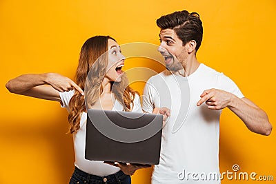 Portrait of excited happy man and woman holding and pointing fin Stock Photo