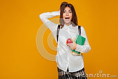 Portrait of an excited schoolgirl holding books Stock Photo