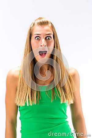 Excited young woman in green tanktop Stock Photo