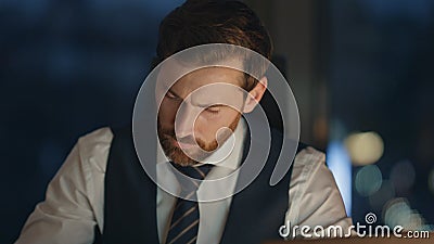 Portrait exhausted businessman working office at night. Busy manager close up. Stock Photo