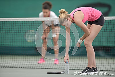 Portrait exhausted female tennis players Stock Photo