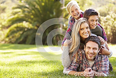 Portrait Of Family Lying On Grass In Countryside Stock Photo