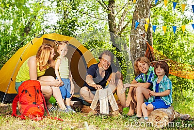 Portrait of family making camp fire in the woods Stock Photo