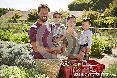 Portrait Of Family Working On Community Allotment Together Stock Photo