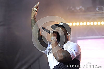 Portrait of famous American rapper 50 Cent while holding the microphone close to his mouth Editorial Stock Photo