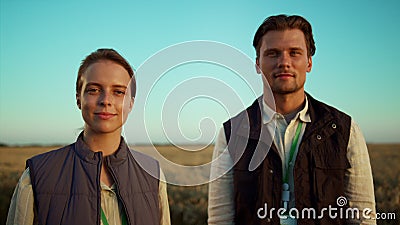 Portrait farmers couple evening countryside. Farmland managers pose together. Stock Photo