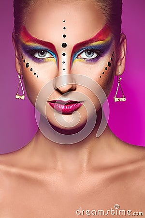 Portrait of fashion model with multicolor make up on purple back Stock Photo