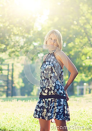 Portrait of fashionable young sensual blonde woman in garden enyoing on the grass field Stock Photo