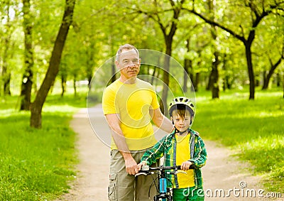 Portrait of father and son with a bicycle Stock Photo