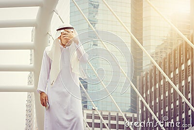 Portrait of feeling strain Arab Middle Eastern Businessman using smartphone in the city background, Success Business concept Stock Photo