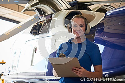 Portrait Of Female Aero Engineer With Clipboard Carrying Out Che Stock Photo