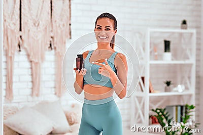 Portrait of female with bottle of capsules in hands Stock Photo
