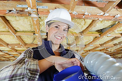 Portrait female builder holding materials Stock Photo