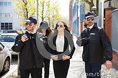 Portrait Of Female Celebrity With Bodyguards Stock Photo