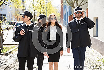 Portrait Of Female Celebrity With Bodyguards Stock Photo