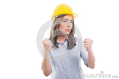 Portrait of female constructor showing fists like fighting Stock Photo