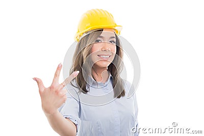 Portrait of female constructor showing number three Stock Photo