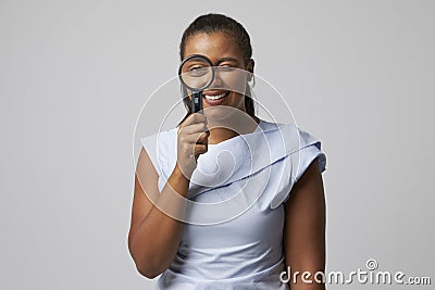 Portrait Of Female Criminologist With Magnifying Glass Stock Photo