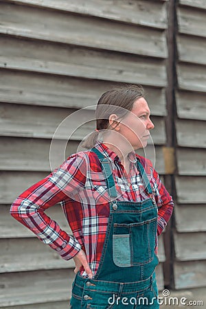 Portrait of female farmer in front of the farmhouse shed Stock Photo