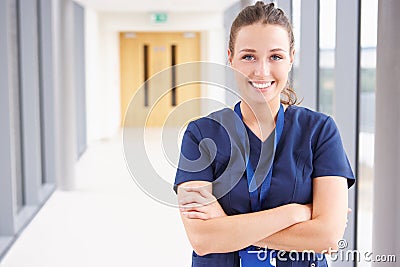 Portrait Of Female Nurse Standing In Hospital Corridor Stock Photo