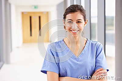 Portrait Of Female Nurse Standing In Hospital Corridor Stock Photo