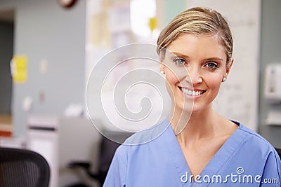 Portrait Of Female Nurse Working At Nurses Station Stock Photo