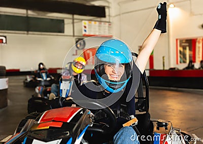 Female racer in helmet driving kart on track Stock Photo