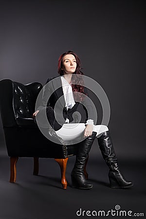 Portrait of female rider in black armchair Stock Photo