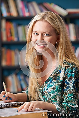 Portrait Of Female Student Working In Library Stock Photo