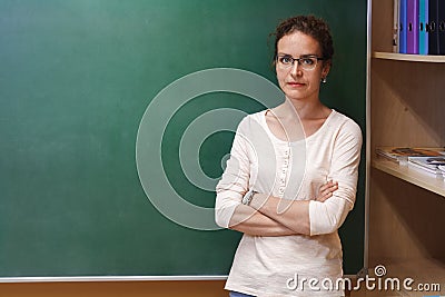 Portrait of a female teacher near the school blackboard Stock Photo
