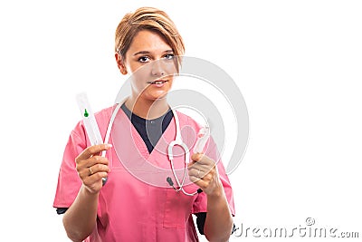 Portrait of female vet wearing pink scrub showing cannula Stock Photo