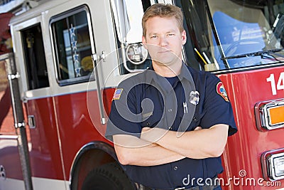 Portrait of a firefighter by a fire engine Stock Photo