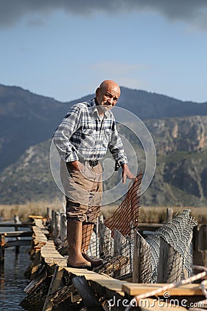 An old fisherman at fishing town in Dalyan, Turkey Editorial Stock Photo