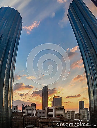 Portrait fisheye lens shot of World Trade Center, Sheikh Mohammed Bin Rashid Tower against a cloudy sunset in Abu Dhabi city Stock Photo