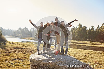 Portrait of five friends standing on a rock in countryside Stock Photo