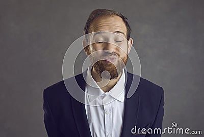 Portrait of a funny man in love pouting his lips and giving a kissing to the camera Stock Photo