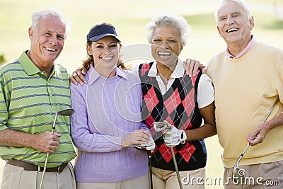 Portrait Of Four Friends Enjoying A Game Golf Stock Photo