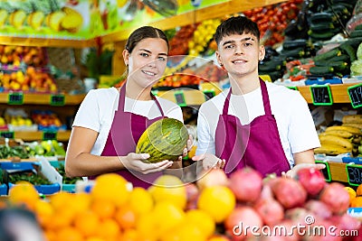 Portrait of friendly salespeople in fruit section of grocery store Stock Photo