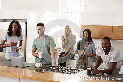 Portrait Of Friends Meeting For Coffee In Modern Kitchen Stock Photo