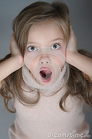 Portrait of a frightened girl who clings to her head and cries. Stock Photo