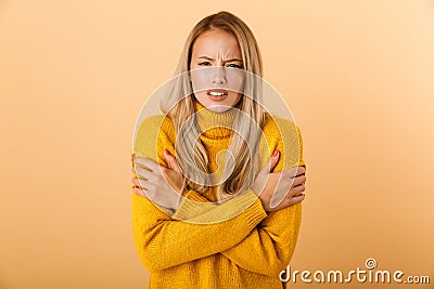 Portrait of a frozen young woman dressed in sweater Stock Photo