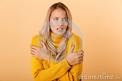 Portrait of a frozen young woman dressed in sweater Stock Photo