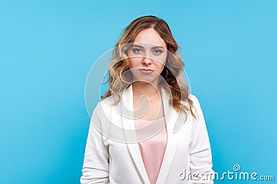 Portrait of frustrated displeased unhappy woman feeling insulted or offended, resentful face. blue background Stock Photo