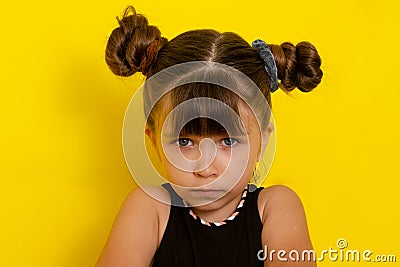 Portrait of a frustrated little kid. Unhappy child looks at the camera. Stock Photo