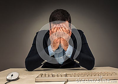 Portrait frustrated young man covering face with hands while Stock Photo