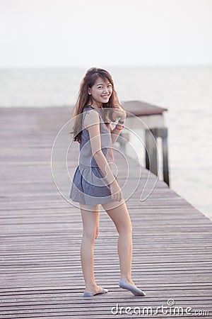 Portrait full slim body with toothy smiling face asian woman re Stock Photo